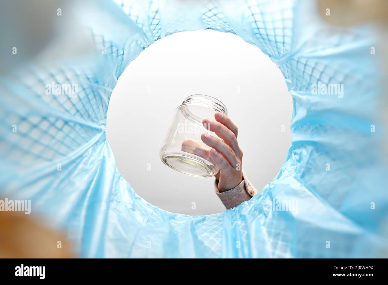 hand throwing glass jar into trash can Stock Photo Alamy