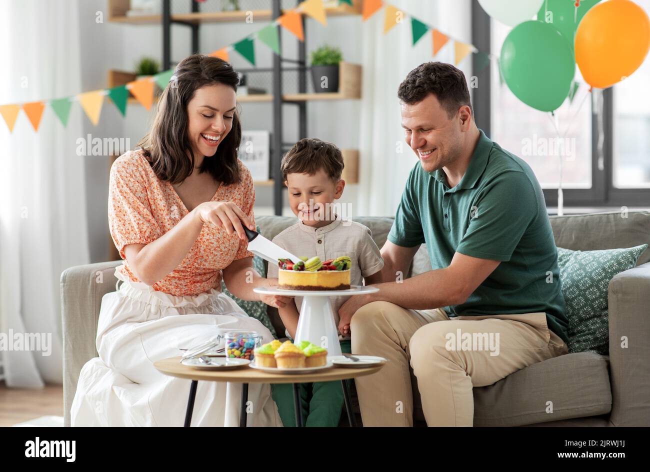happy family with birthday cake at home Stock Photo