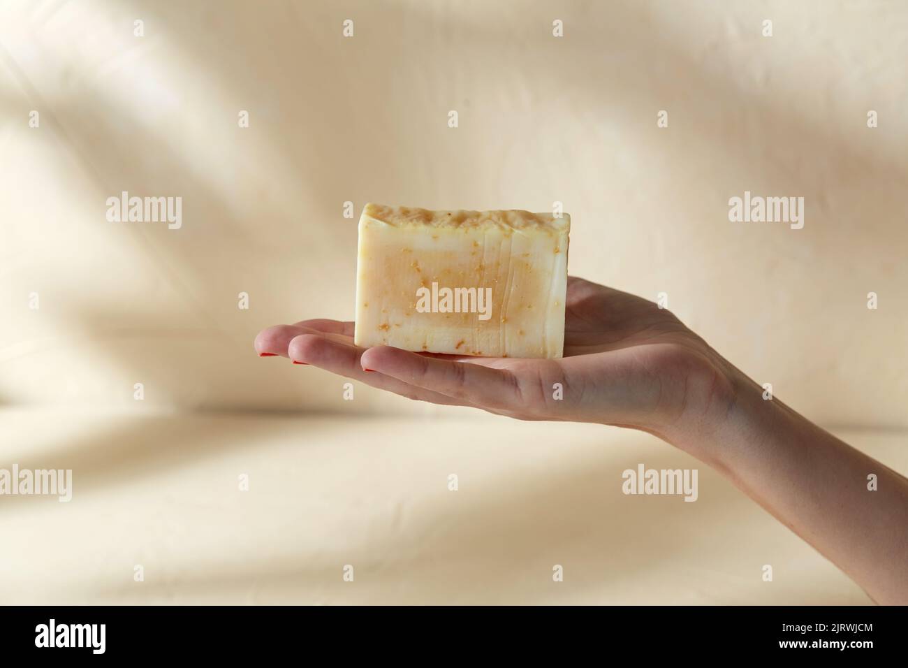 hand holding bar of craft soap on beige background Stock Photo Alamy