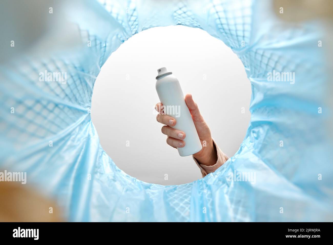 hand throwing hair spray bottle into trash can Stock Photo - Alamy