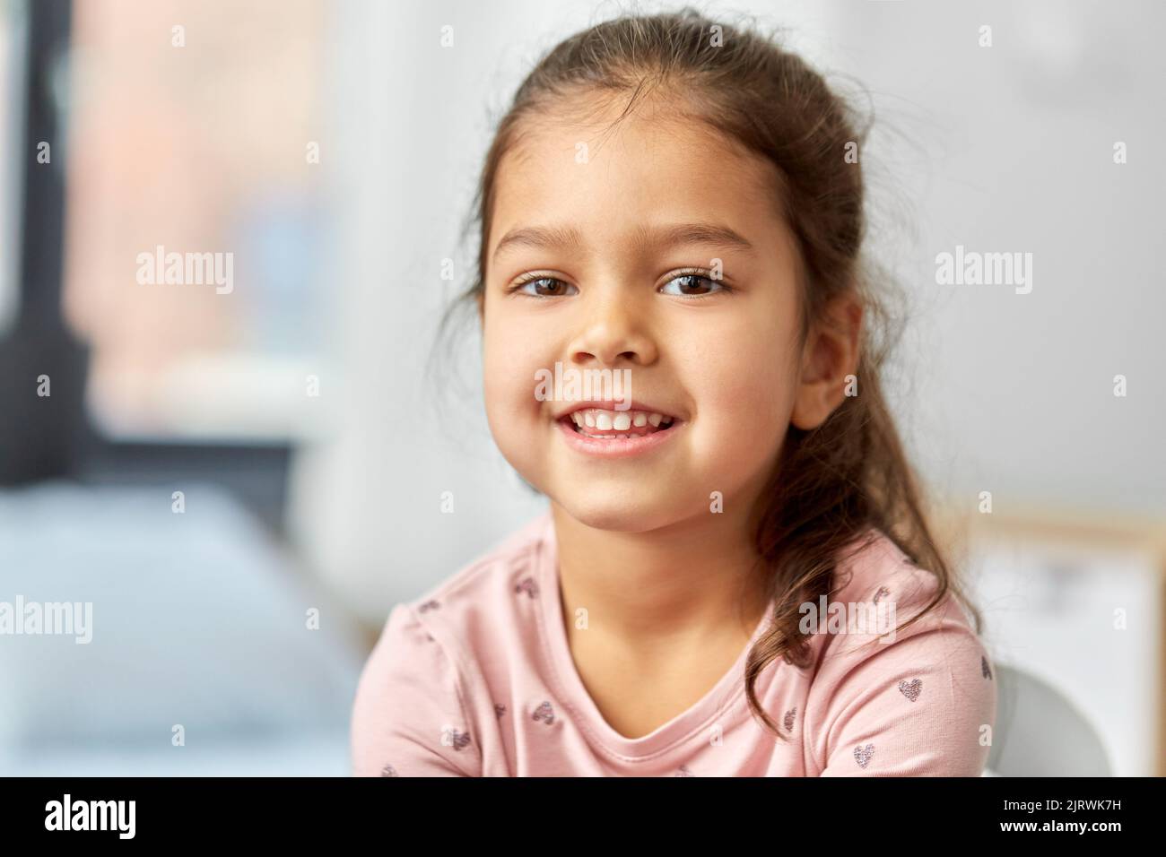 portrait of happy smiling little girl at home Stock Photo Alamy