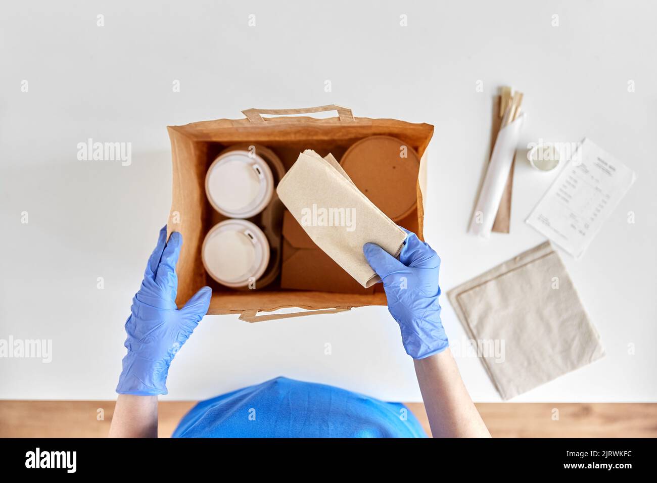 delivery woman in gloves packing food and drinks Stock Photo - Alamy