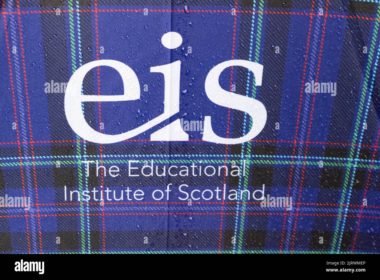 EIS - Educational Institute of Scotland teaching union logo on tartan umbrella Stock Photo