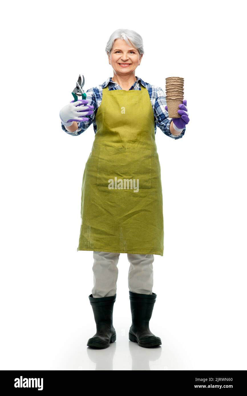 old woman in apron with pruner and flower pots Stock Photo - Alamy