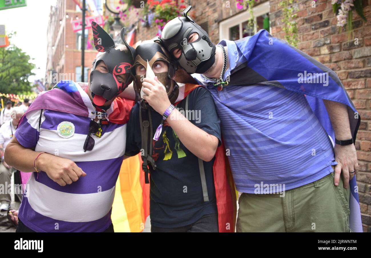 Manchester, UK. 26th August, 2022. Three men wear dog masks. LGBTQ+ Pride, Manchester, UK, begins and continues over the Bank Holiday weekend 26th to 29th August in Manchester's gay village. Organisers say: 'Manchester Pride is one of the UK's leading LGBTQ+ charities. Our vision is a world where LGBTQ+ people are free to live and love without prejudice. We’re part of a global Pride movement celebrating LGBTQ+ equality and challenging discrimination.' Credit: Terry Waller/Alamy Live News Stock Photo