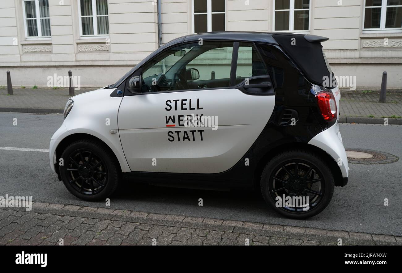 Detmold, NRW, Germany - Aug 20 2022 A cute electric car in black and white with a company name on it. Smart EQ ForTwo Electric Drive Stock Photo