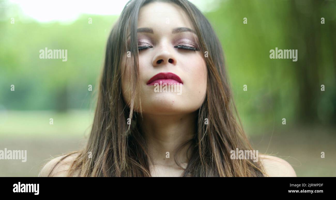 Girl in her 20s taking a deep breath. Young woman breathing the fresh