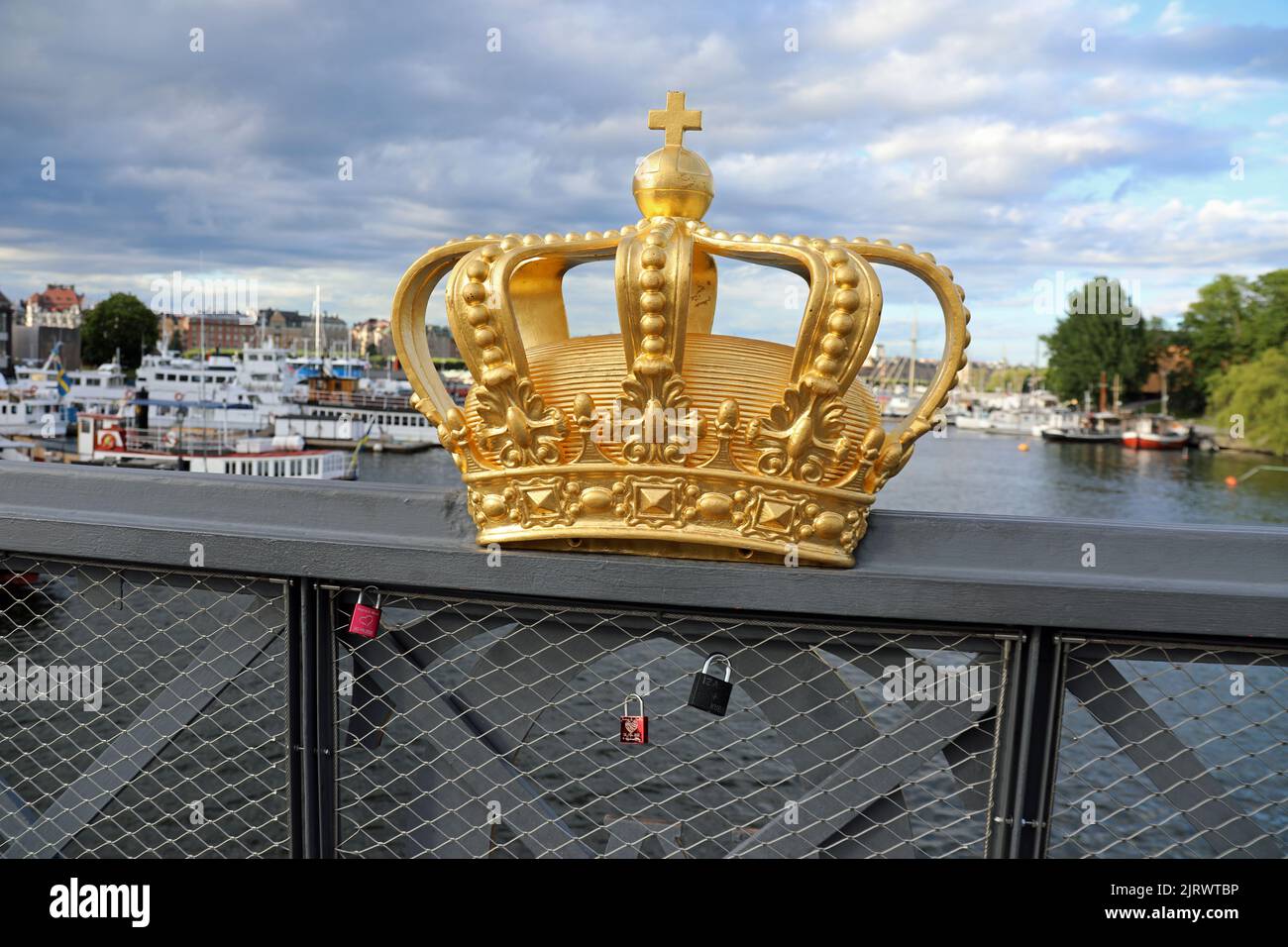 Gilded crown on Skeppsholmen Bridge in Stockholm Stock Photo