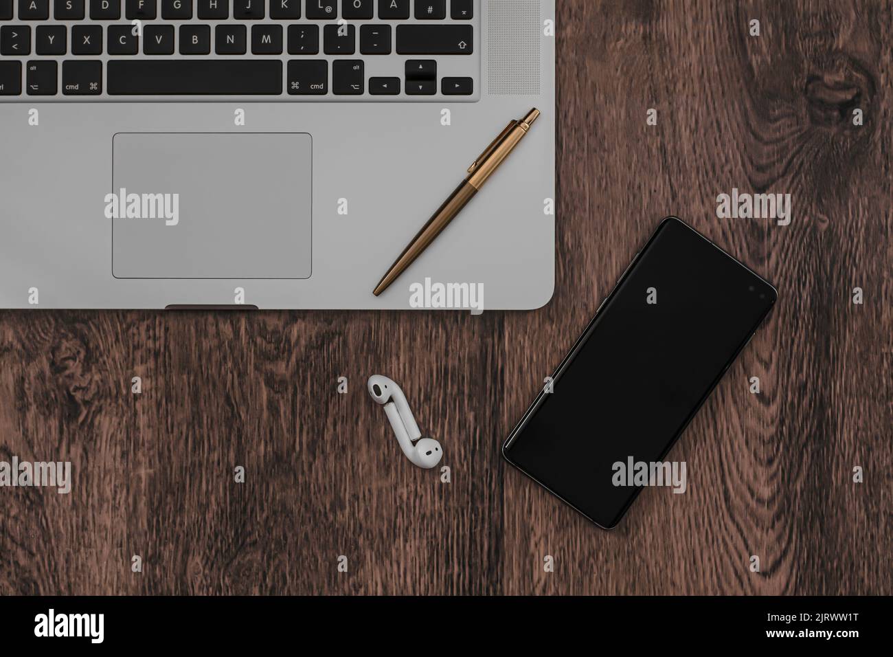 work from home with a smartphone, headphones and laptop setup Stock Photo