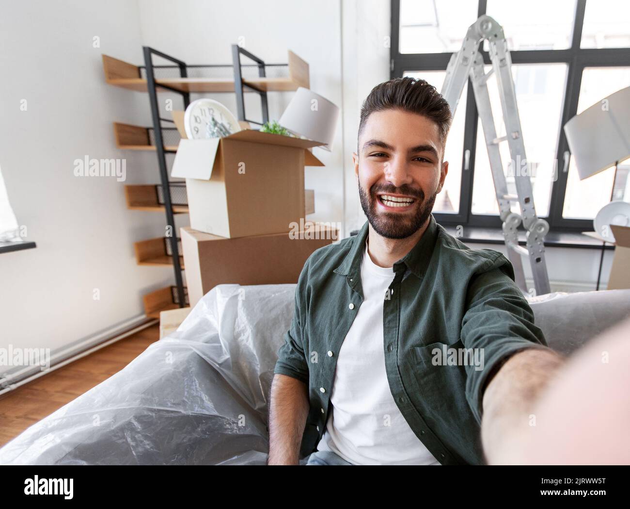 man having video call and moving into new home Stock Photo Alamy