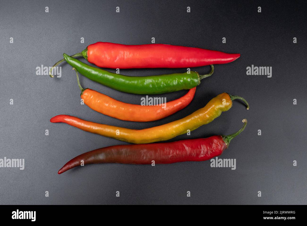 spicy asorti chili peppers green and red color Stock Photo - Alamy