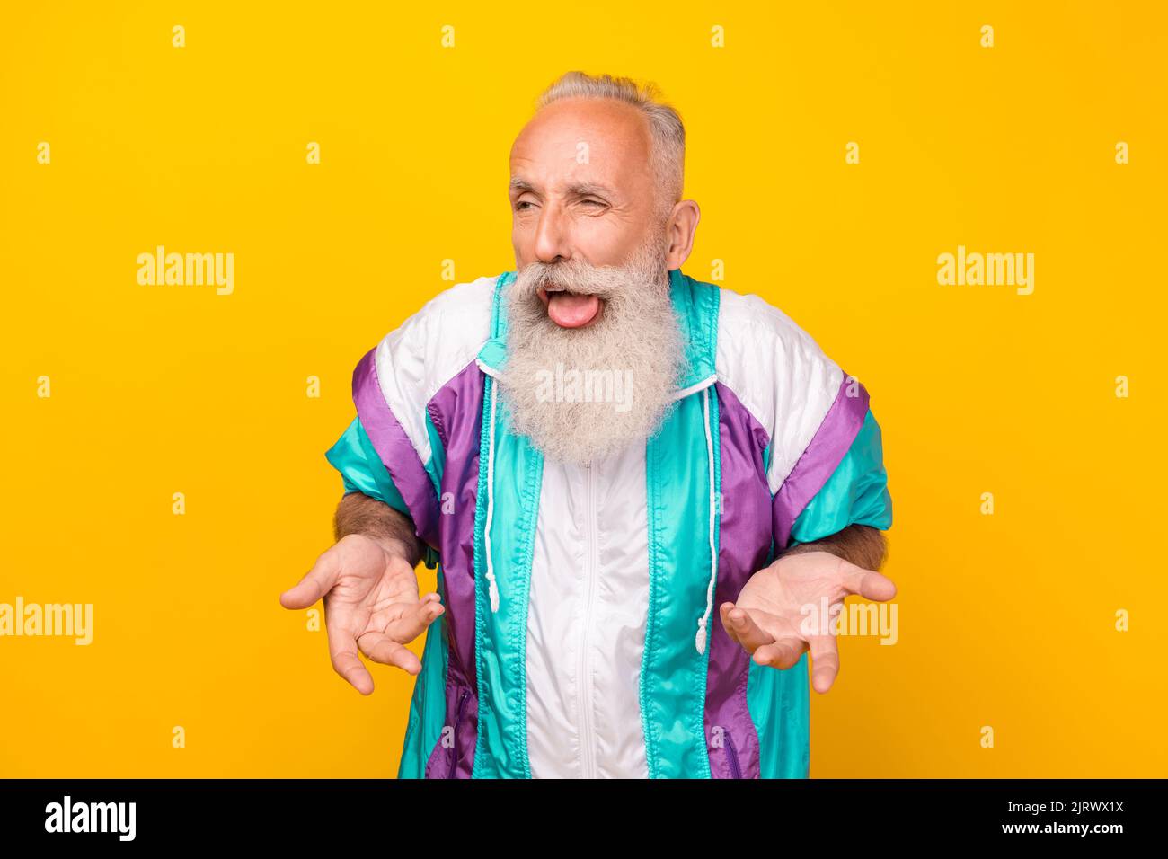 Portrait of funky aged person make foolish face arms palms mocking chatterbox isolated on yellow color background Stock Photo