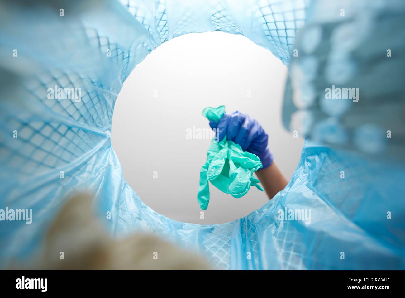 hand throwing used medical gloves into trash can Stock Photo Alamy