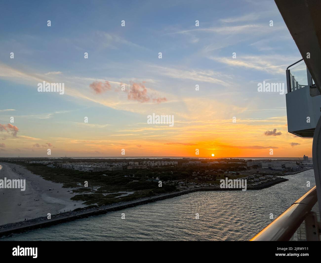 An aerial view of  Port Canaveral at sunset during a cruise ship sail away in Florida. Stock Photo