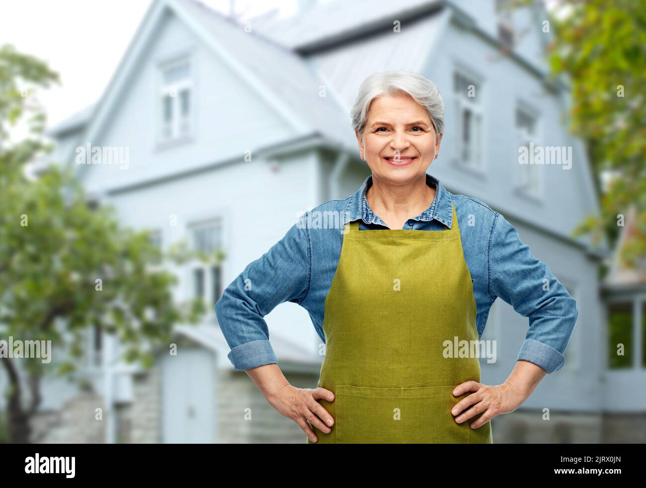 portrait of smiling senior woman in garden apron Stock Photo - Alamy