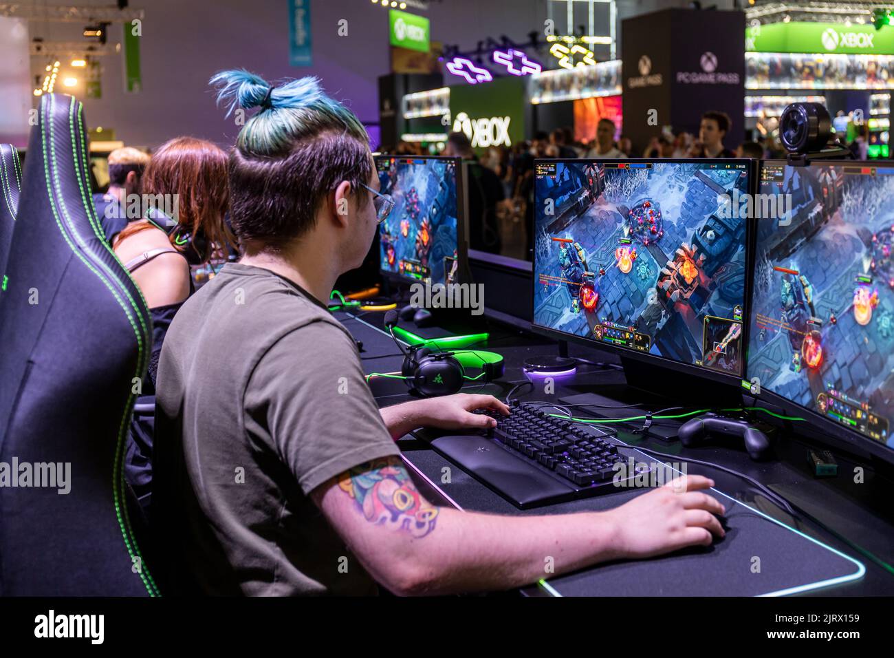 Cologne, Germany. 24th Aug, 2022. Gamescom 2022: Gamers playing the multiplayer online battle arena video game League of Legends at Razer booth. Gamescom is the world's largest trade fair for computer and video games, at Koelnmesse in Cologne, Germany. Credit: Christian Lademann / LademannMedia Stock Photo