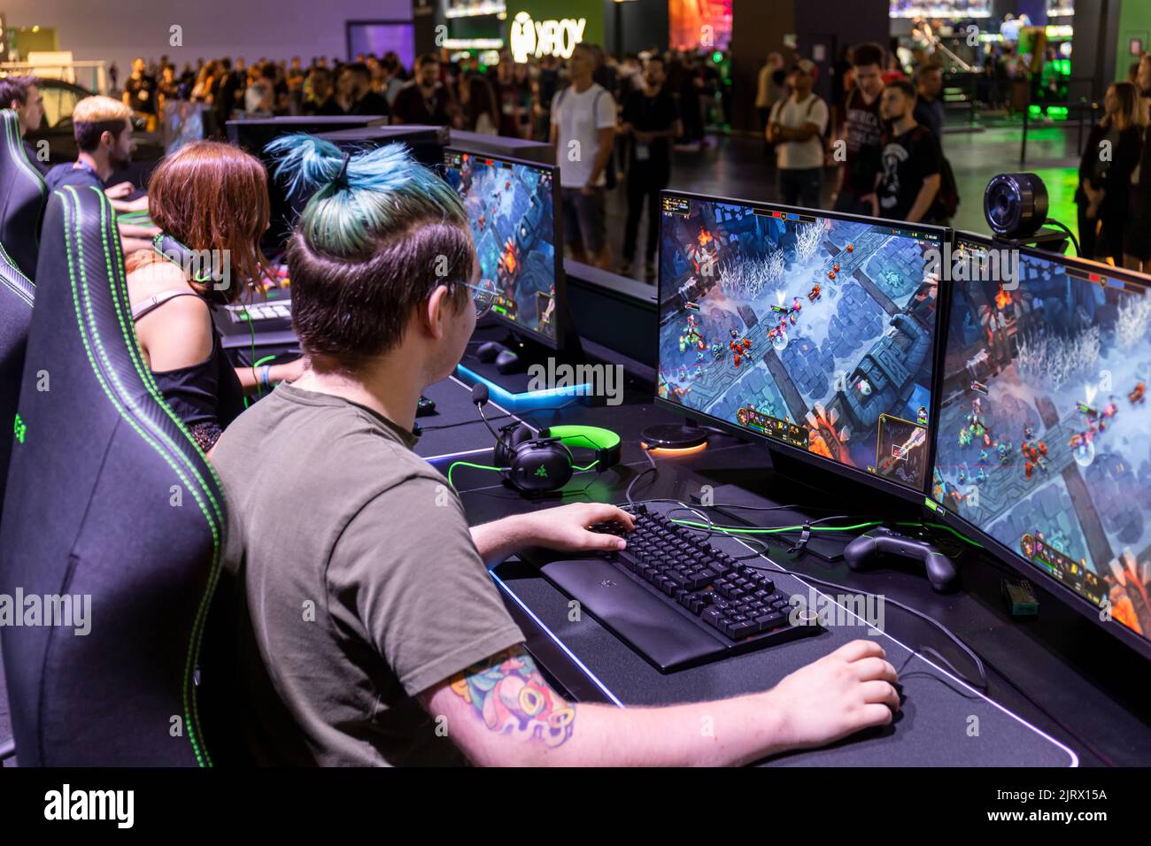 Cologne, Germany. 24th Aug, 2022. Gamescom 2022: Gamers playing the multiplayer online battle arena video game League of Legends at Razer booth. Gamescom is the world's largest trade fair for computer and video games, at Koelnmesse in Cologne, Germany. Credit: Christian Lademann / LademannMedia Stock Photo