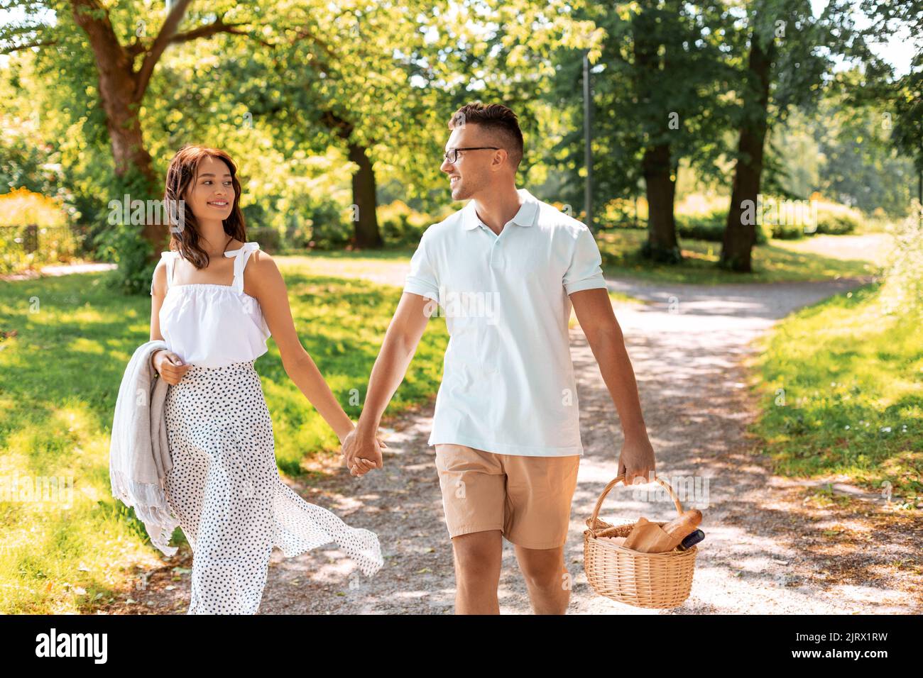 happy couple with picnic basket at summer park Stock Photo