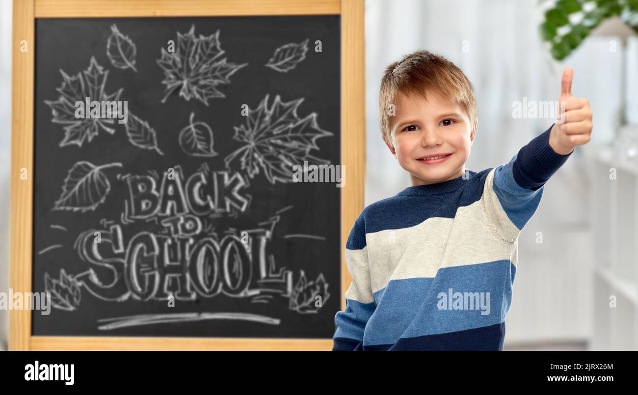 little student boy showing thumbs up Stock Photo - Alamy
