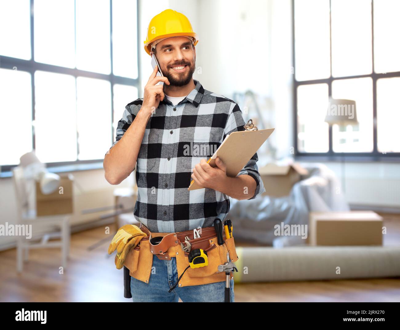 builder calling on smartphone at home Stock Photo