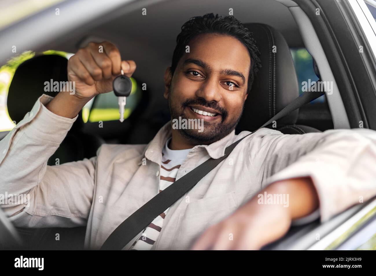 smiling indian man or driver showing car key Stock Photo