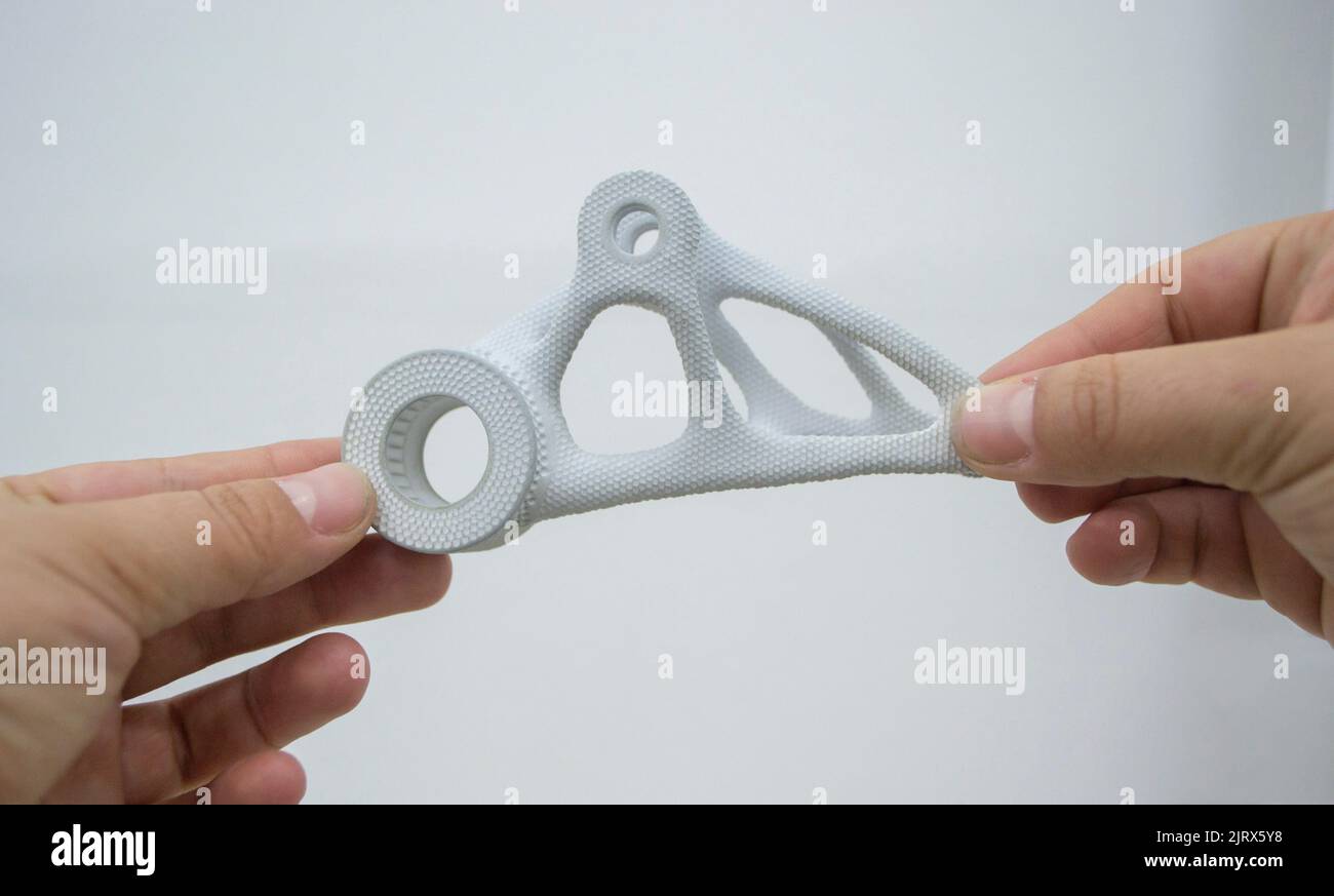 Person holding plastic model printed on powder 3d printer from powder ...