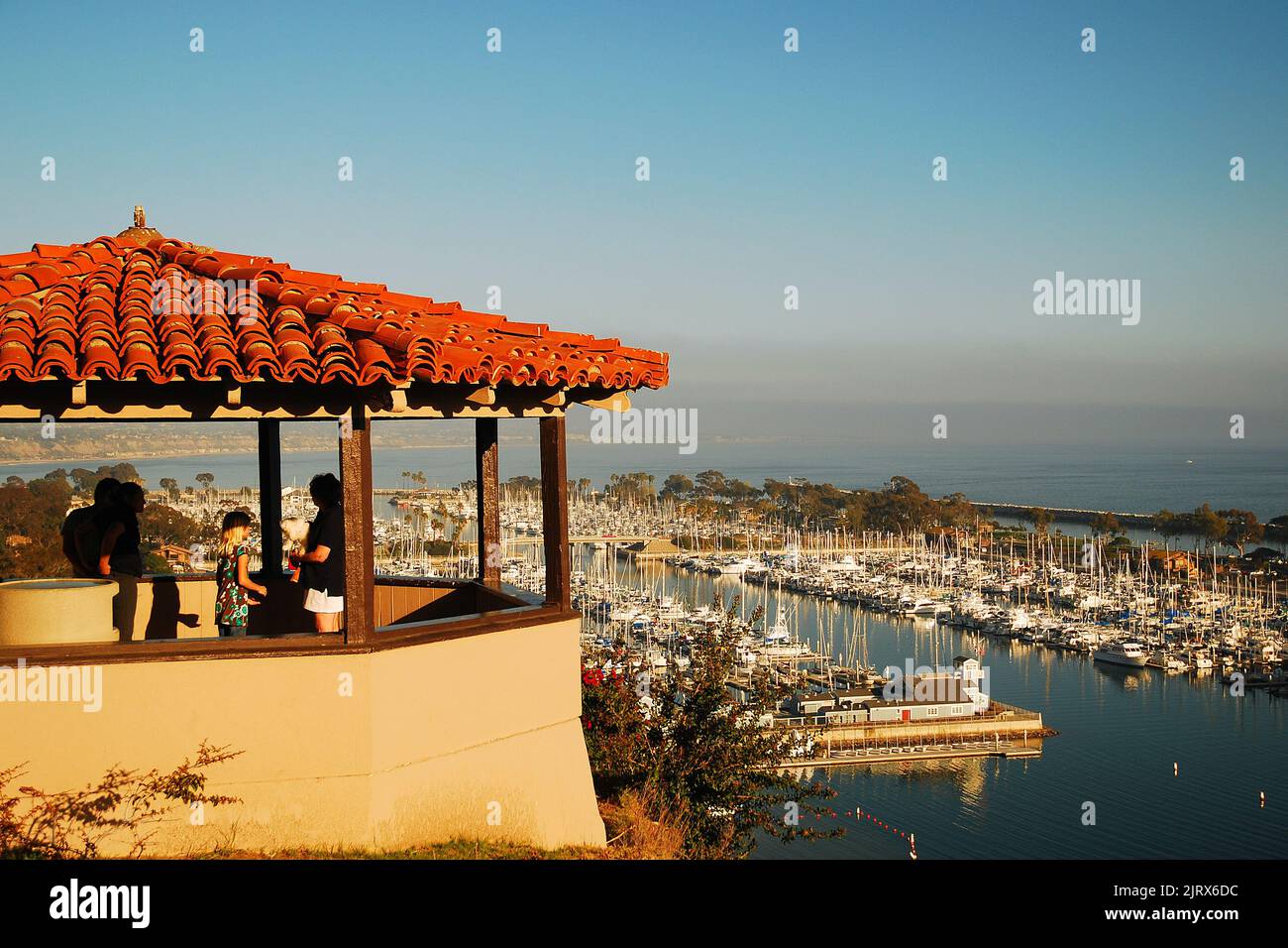 A red tiled gazebo perched high on a cliff gives a wonderful view of the harbor at Dana Point Stock Photo
