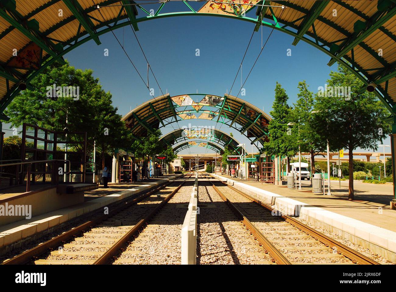 A circular metal canopy hangs over the LBJ Central Station, on the Dallas DART Light Rail Train System, a large public transportation service in Texas Stock Photo