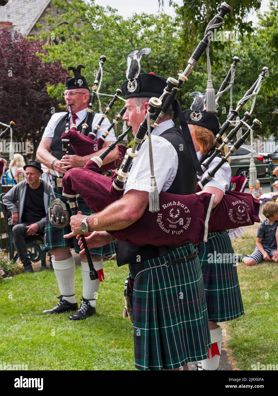 Pipers in traditional dress play at the 2022 Rothbury music festival, Northumberland, UK Stock Photo