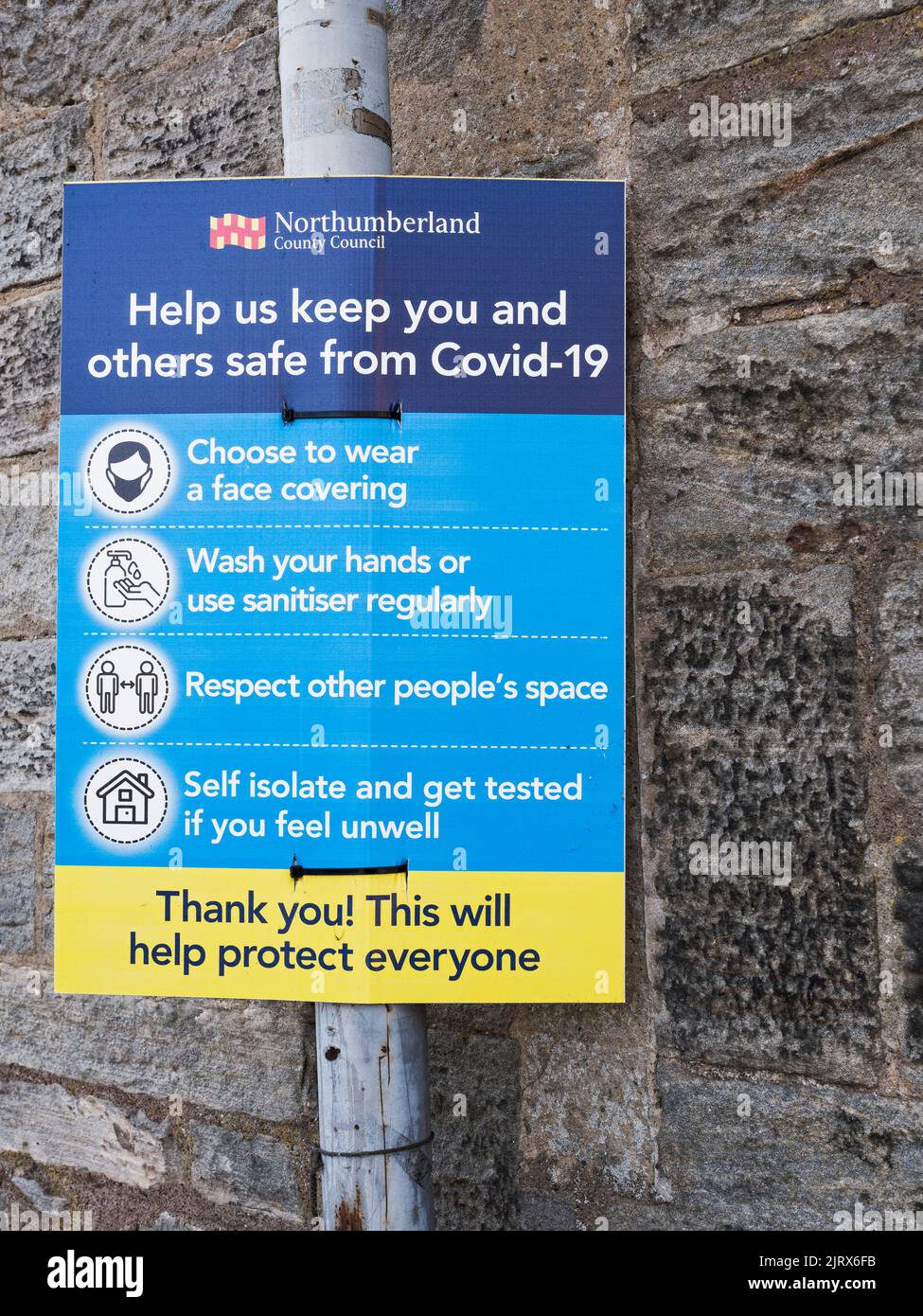 Sign reminding of Covid-19 personal safety during the coronavirus pandemic Stock Photo