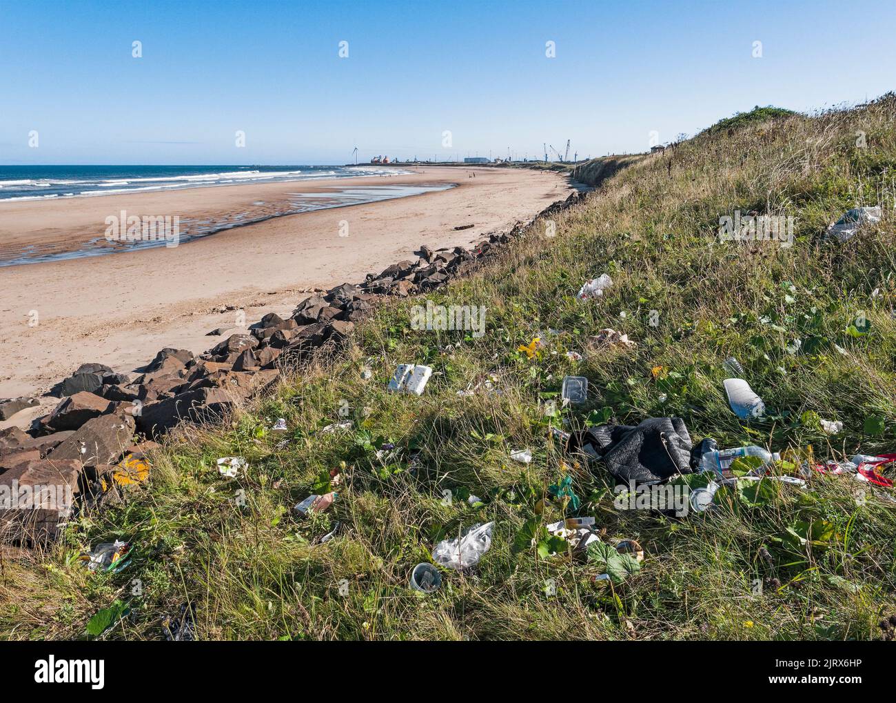 Litter dumped at Cambois, Northumberland, UK beside a pristine beach. Stock Photo