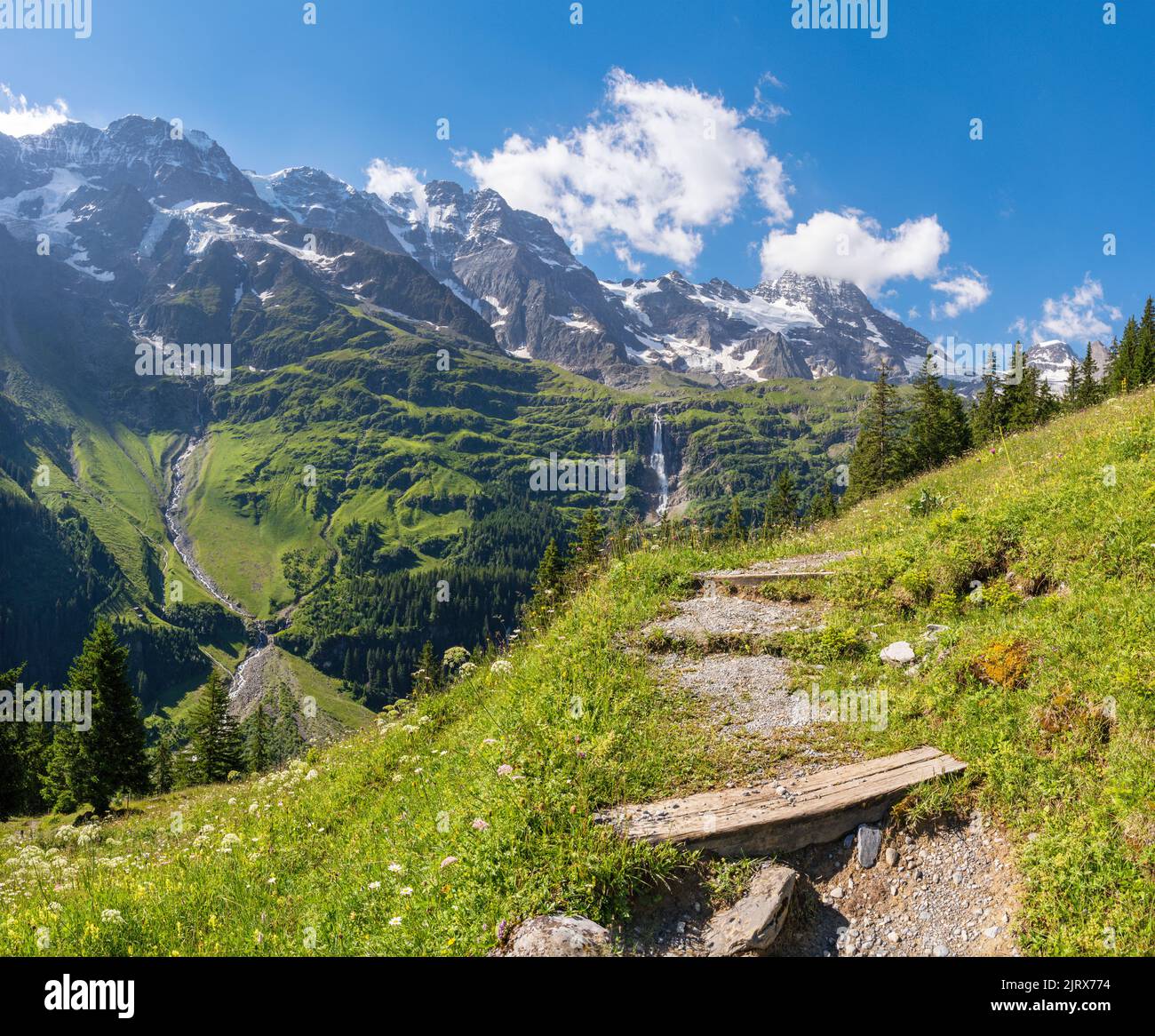 The Hineres Lauterbrunnental valley with the peaks Mittaghorn and Grosshorn and Breithorn and the typically chalet. Stock Photo