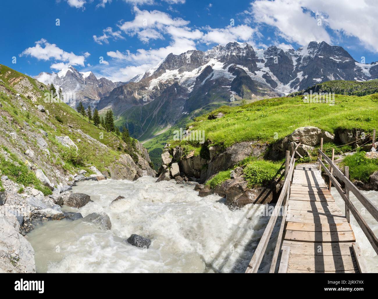 The glacial stream with the Jungfrau, Mittaghorn and Grosshorn peaks in the Hineres Lauterbrunnental valley. Stock Photo