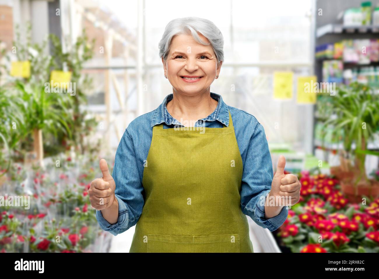 senior woman showing thumbs up in gardening center Stock Photo - Alamy