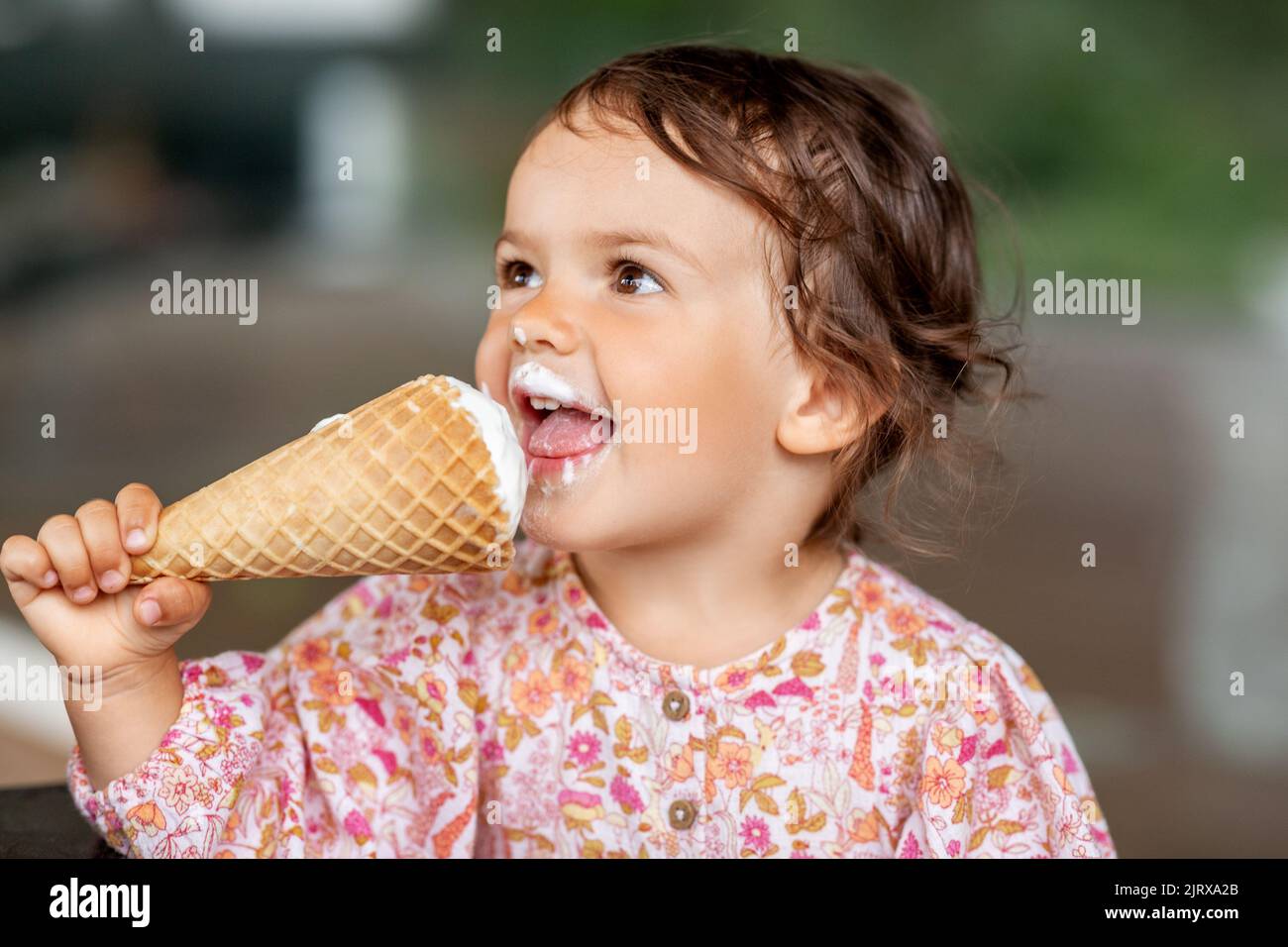 happy little baby girl eating ice cream Stock Photo Alamy