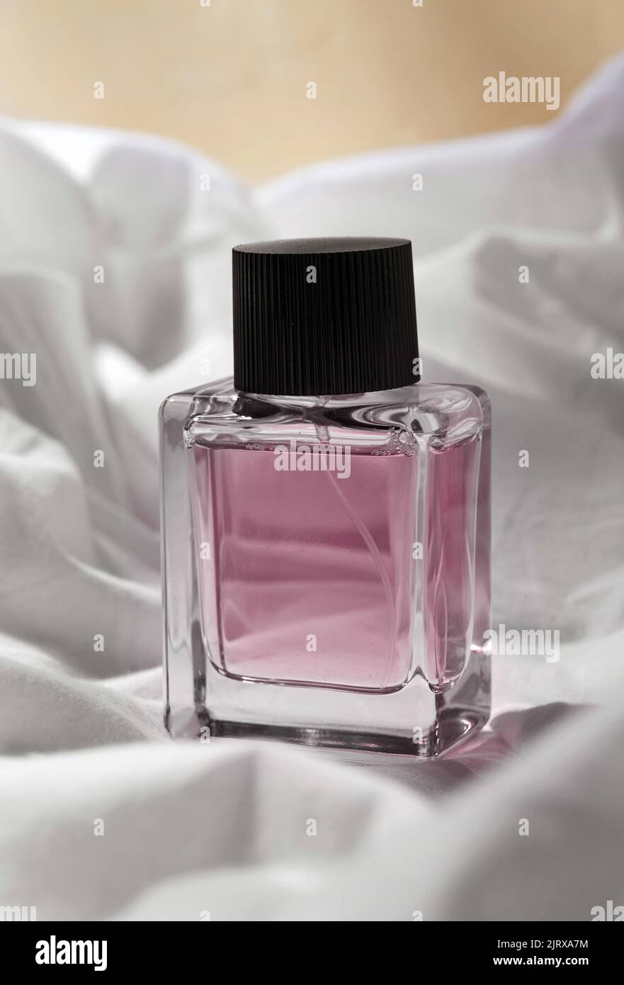 bottle of perfume on white sheet Stock Photo Alamy