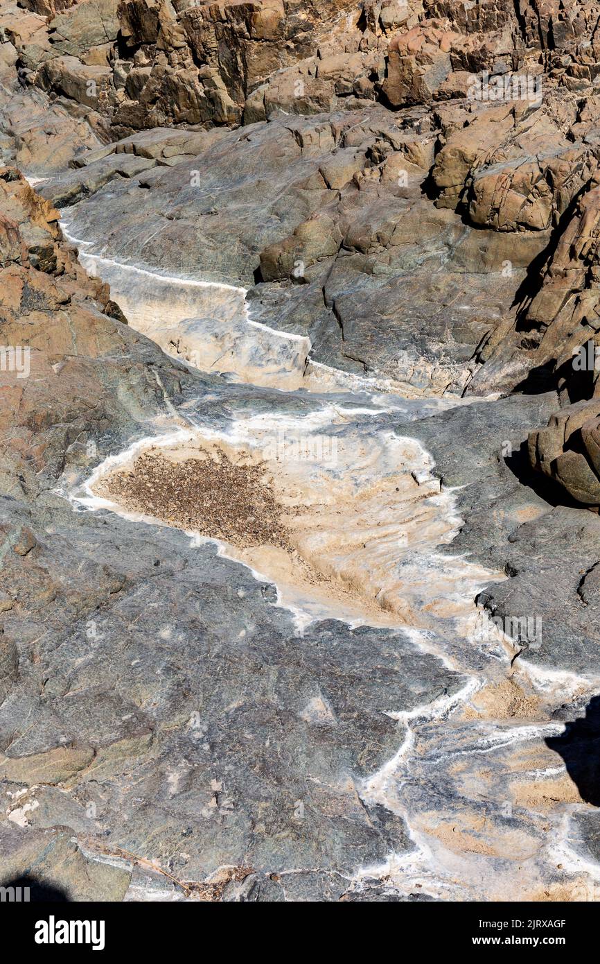 Wadi Shawka pools mountain trail in Hajar Mountains, United Arab Emirates, stony, dry riverbed in rocky valley. Stock Photo