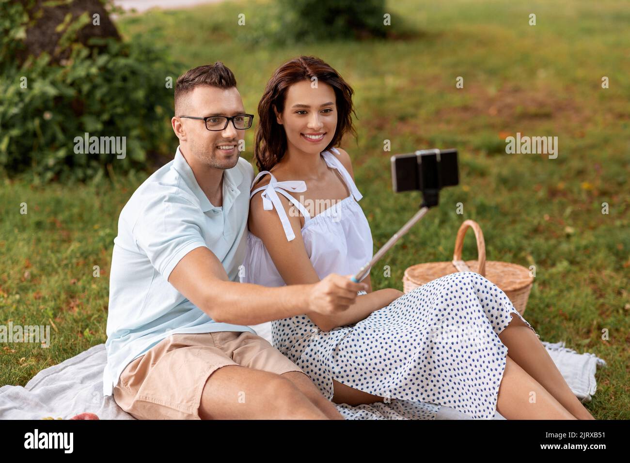 happy couple taking selfie at picnic in park Stock Photo - Alamy