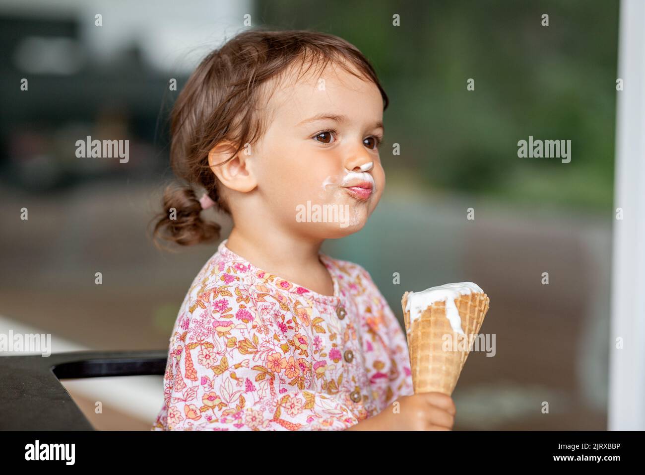 happy little baby girl eating ice cream Stock Photo Alamy