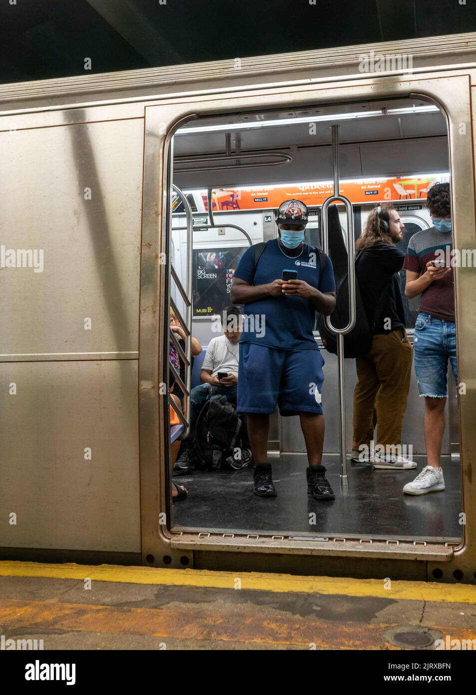 Distracted subway travelers in the Carroll Street station in Carroll