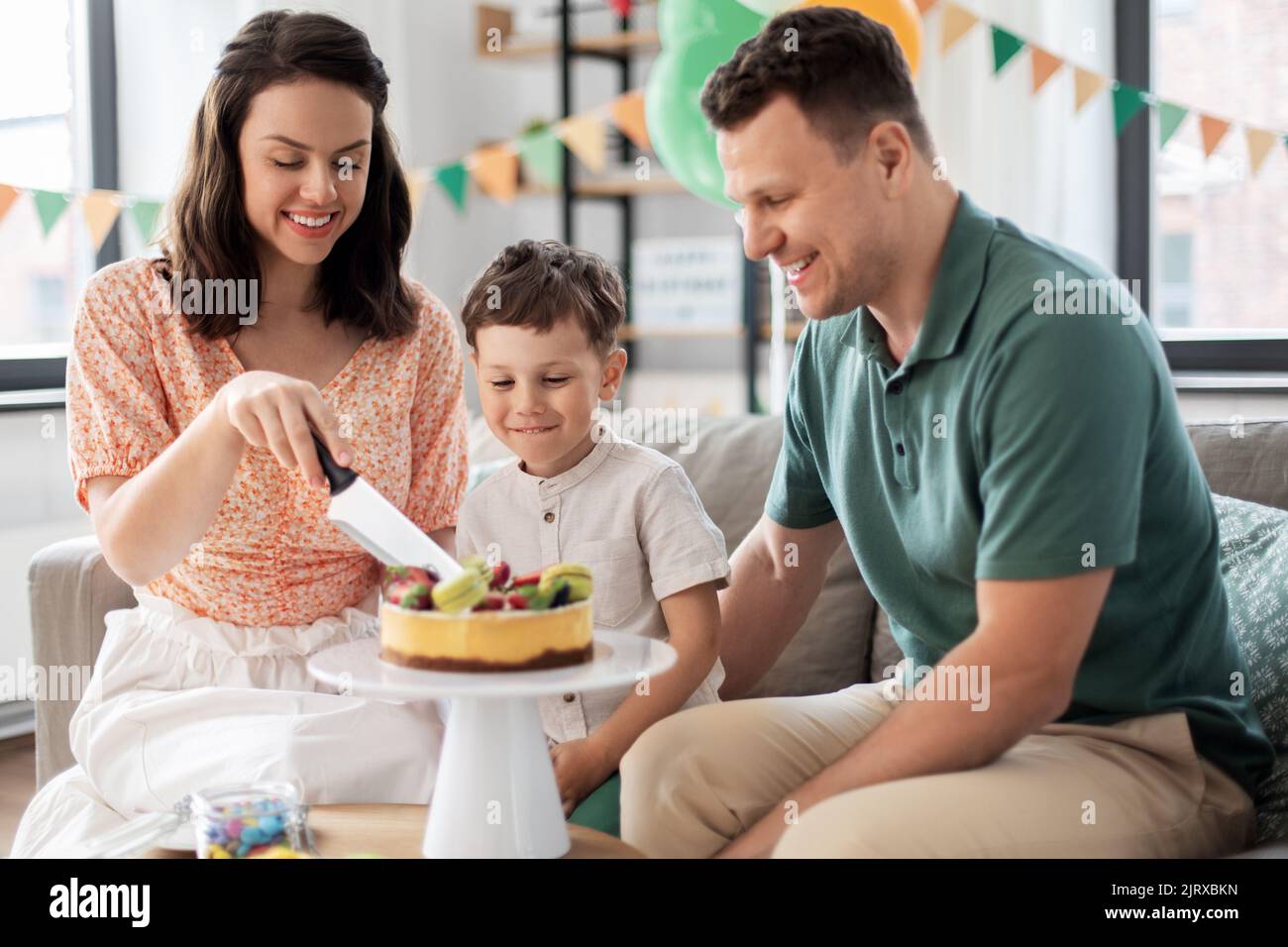 happy family with birthday cake at home Stock Photo