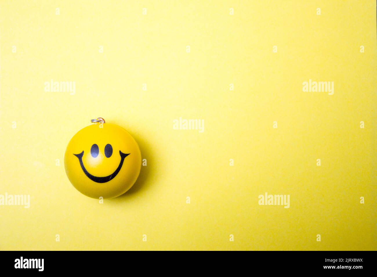 Photo of a yellow smiley face on yellow background Stock Photo