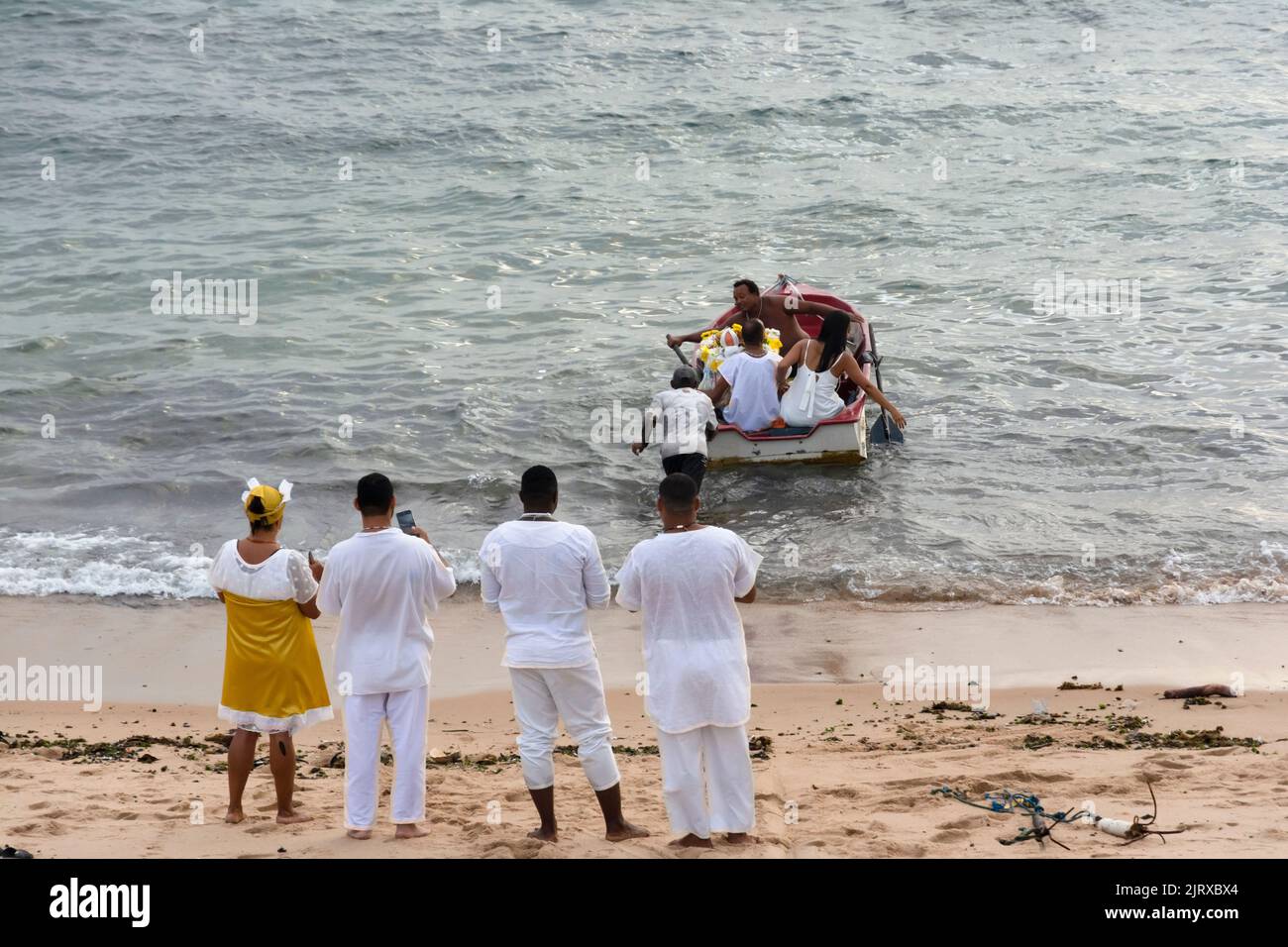 A view of Candomble members delivering gifts to Iemanja, the queen of the sea, at Rio Vermelho beach Stock Photo