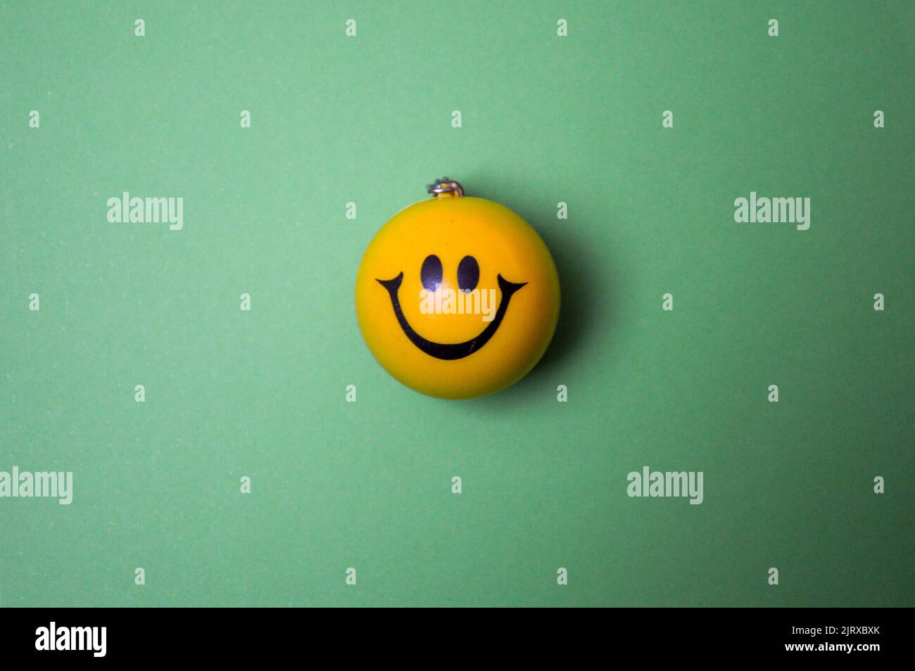 Photo of a yellow smiley face on green background Stock Photo