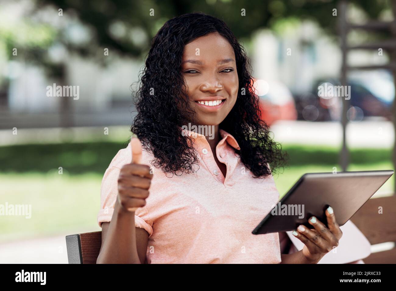 Thumbs up african woman sitting hi-res stock photography and images - Alamy