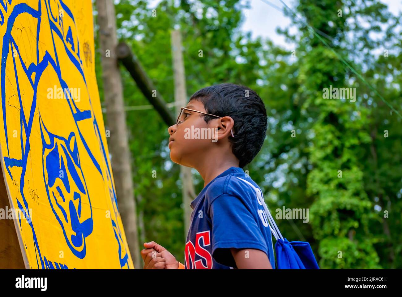 A Cub Scout signs a flag at Camp Seminole, June 24, 2011, Starkville