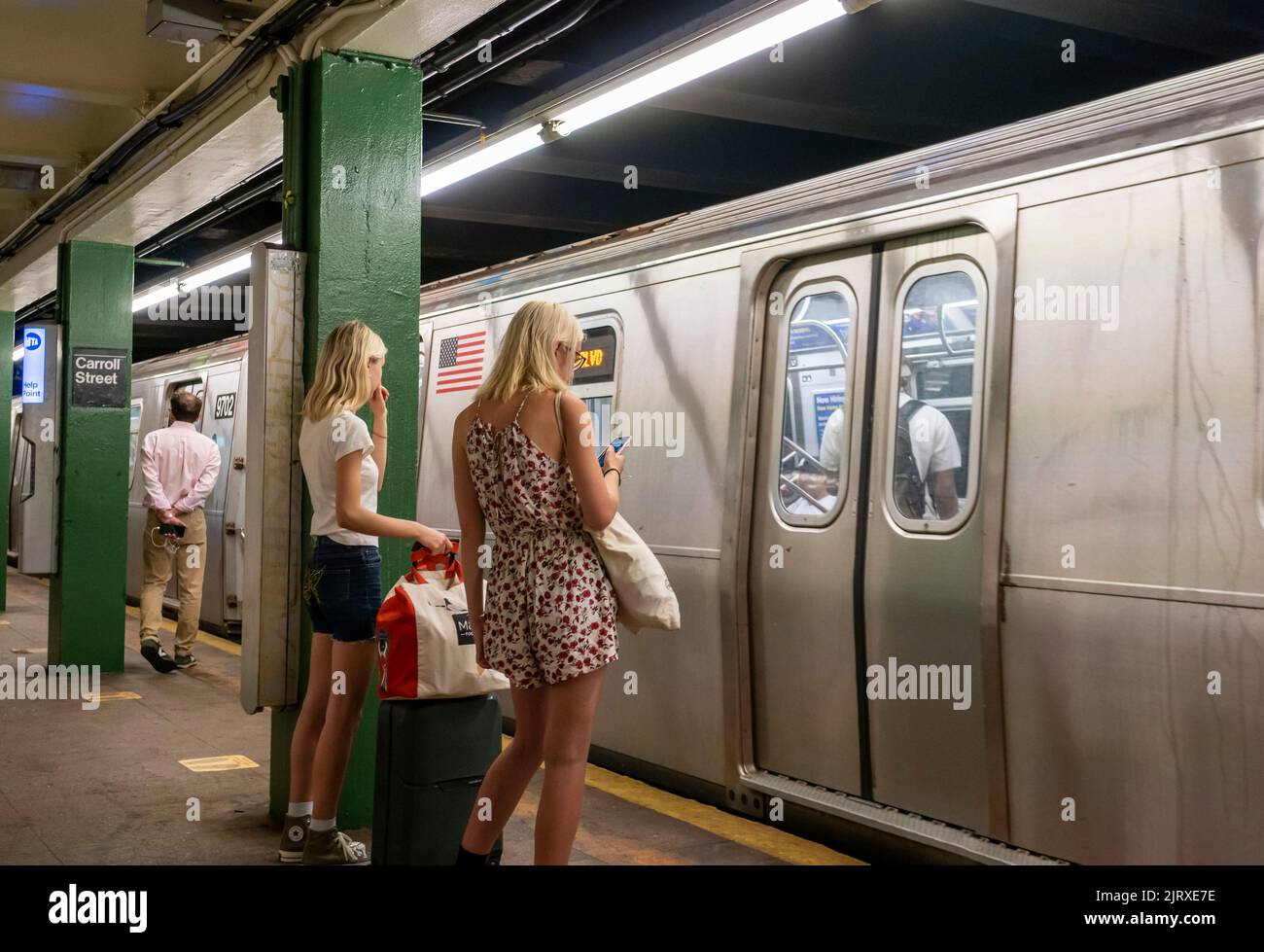 Distracted subway travelers in the Carroll Street station in Carroll