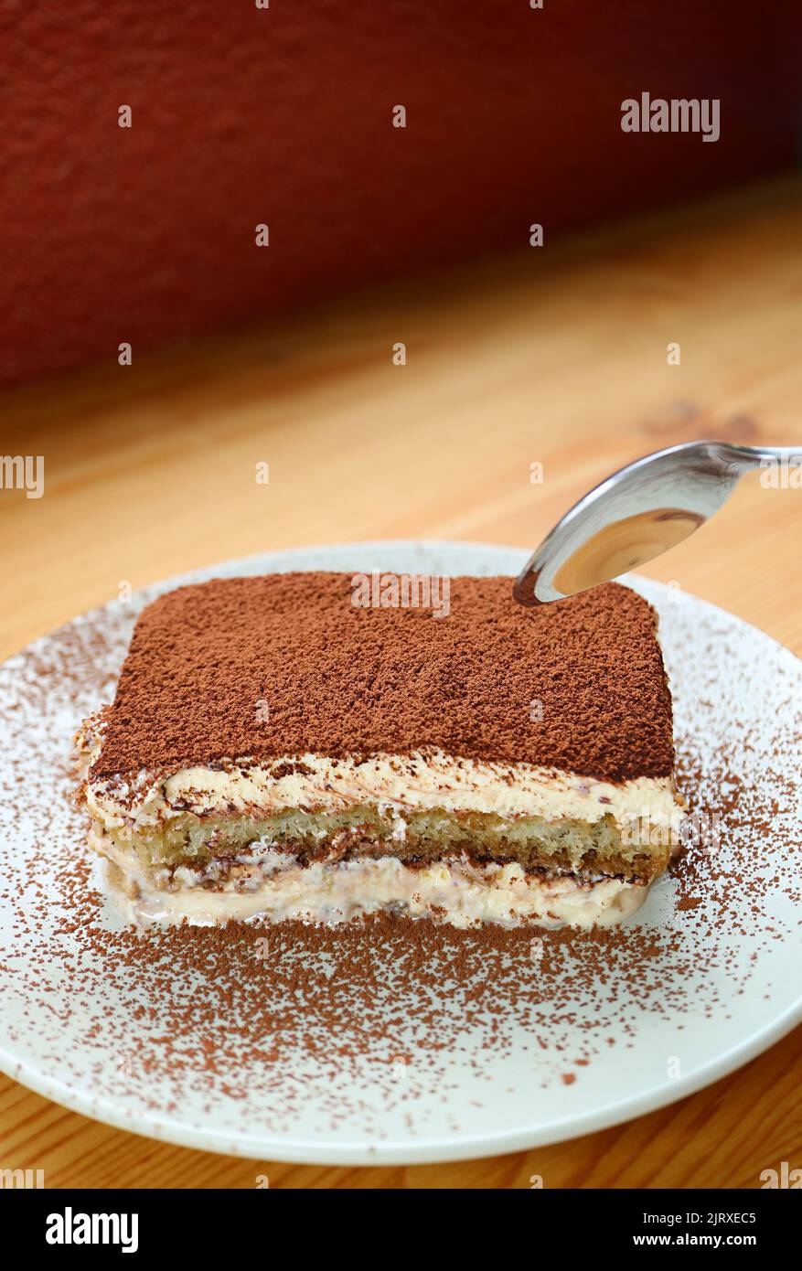 Plate of Delectable Tiramisu on Wooden Table Stock Photo
