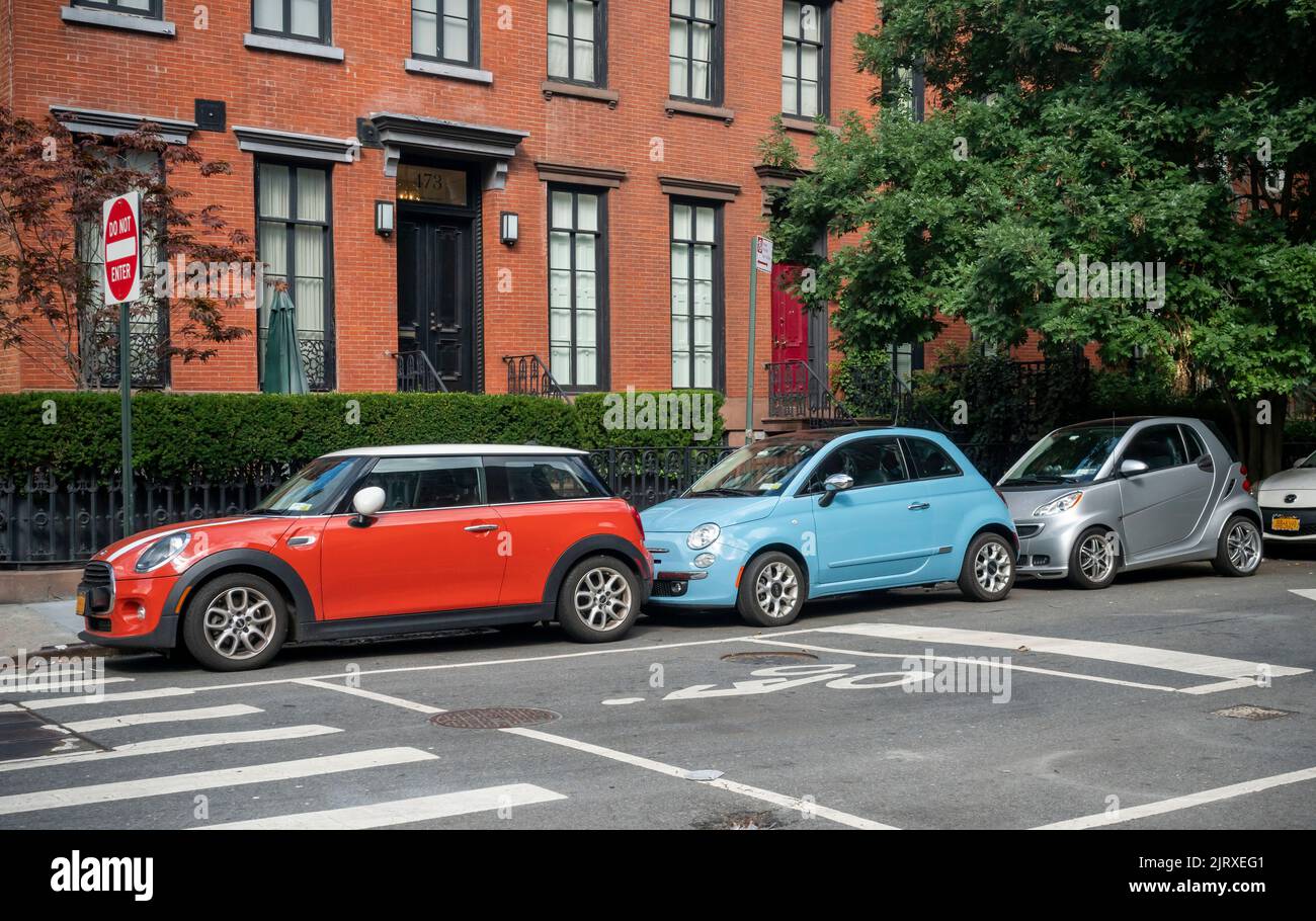 A Mini Cooper, manufactured by BMW, a Fiat, manufactured by Stellantis and a Smart Car, manufactured by Daimler, all lined up in a row in Chelsea in New York on Tuesday, August 23, 2022.   (© Richard B. Levine) Stock Photo