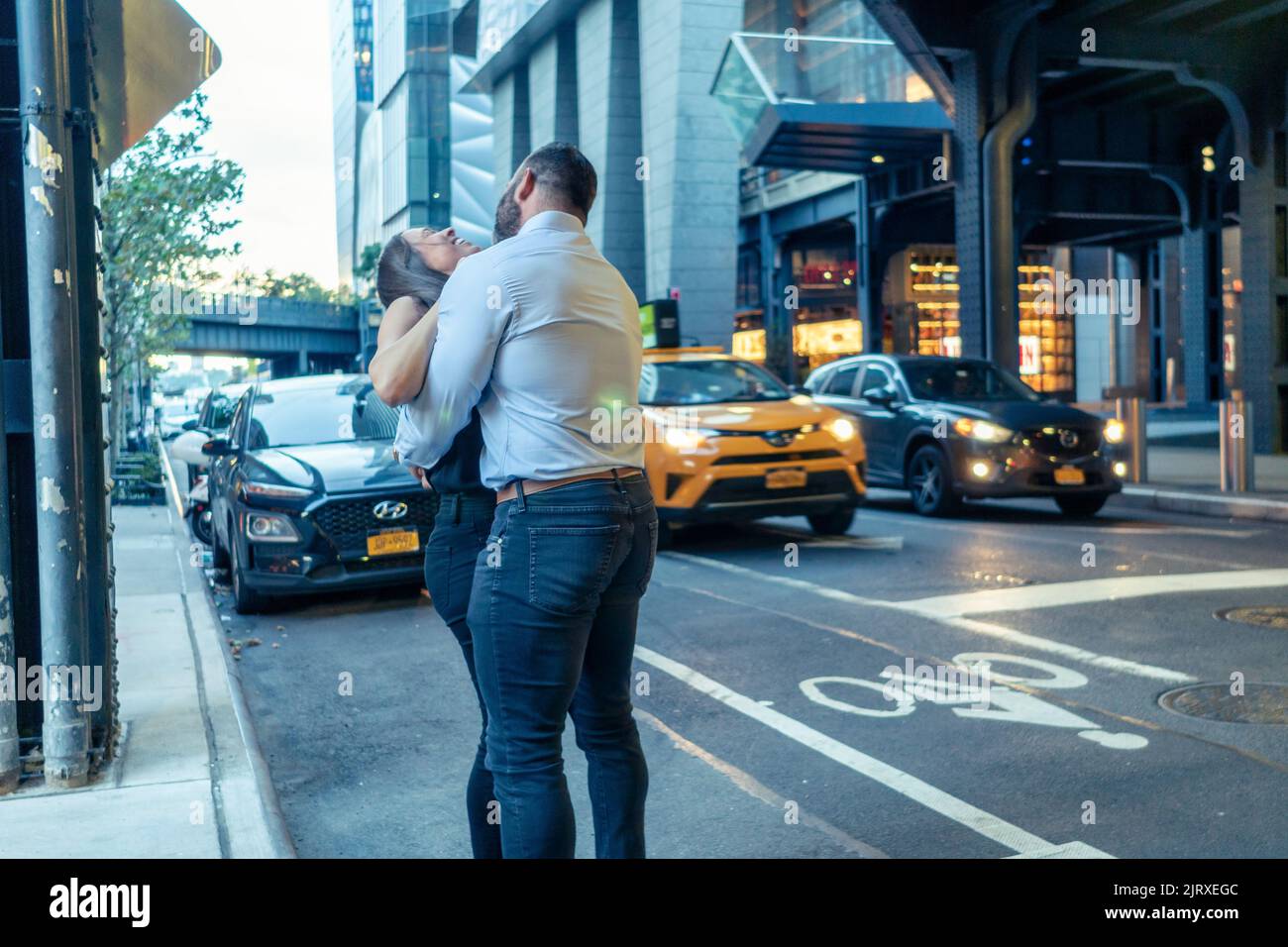 A kiss and a hug under the High Line near Hudson Yards in New York on Tuesday, August 23, 2022.  (© Richard B. Levine) Stock Photo